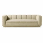 Front view of The Plinth Premium Sofa in cream boucle fabric with rounded arms, channel backrest, and low upholstered base.